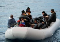 migrants are seen on a dinghy following a failed attempt to cross to the greek island of lesbos as a turkish coast guard boat aproaches them on the waters of the north aegean sea off the shores of canakkale turkey march 6 2020 photo reuters