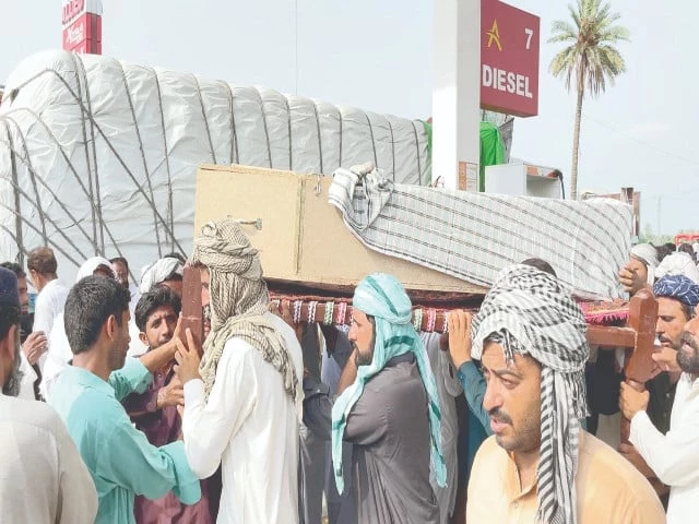 mourners in multan carry the coffin of a victim of the latest terrorist carnage in balochistan to graveyard photo online