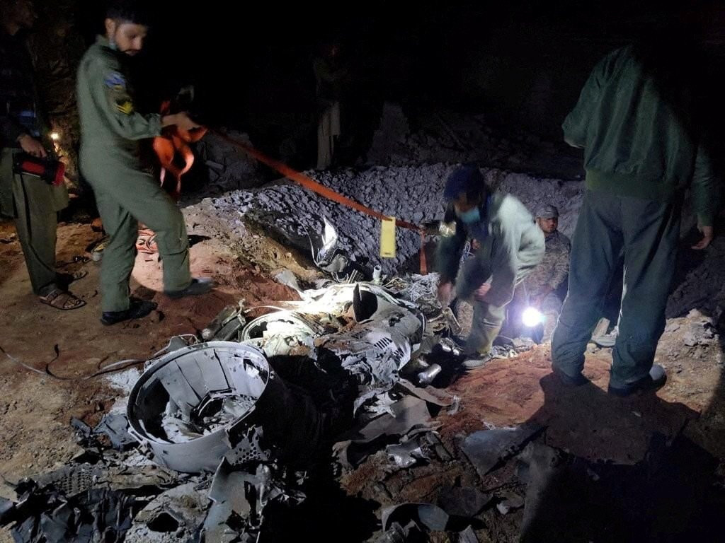 people work around the remains of a missile fired into pakistan from india near mian channu pakistan march 9 2022 photo reuters