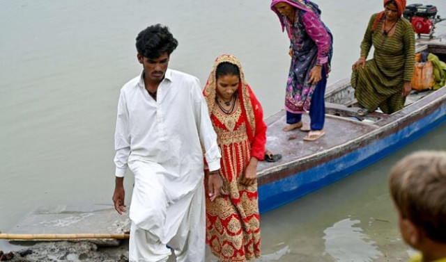 in this photograph taken on august 3 2024 newly married underage monsoon bride amina 2l with their husband mohammad usman l arrives at the khan muhammad mallah village in main nara valley dadu district sindh province photo afp in this photograph taken on august 3 2024 newly married underage monsoon bride amina 2l with their husband mohammad usman l arrives at the khan muhammad mallah village in main nara valley dadu district sindh province photo afp