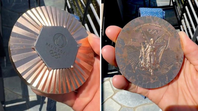 olympian nyjah huston showing his bronze medal with losing color and wear and tear photo nyjah olympian nyjah huston showing his bronze medal with losing color and wear and tear photo nyjah