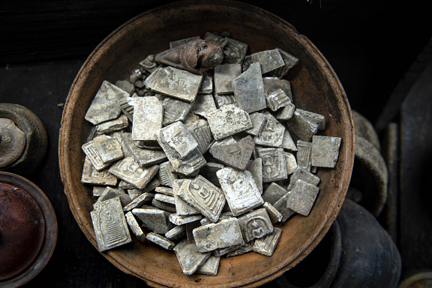 Buddhist stone amulets recovered by divers from the bottom of Bangkok's Chao Phraya river, PHOTO: AFP