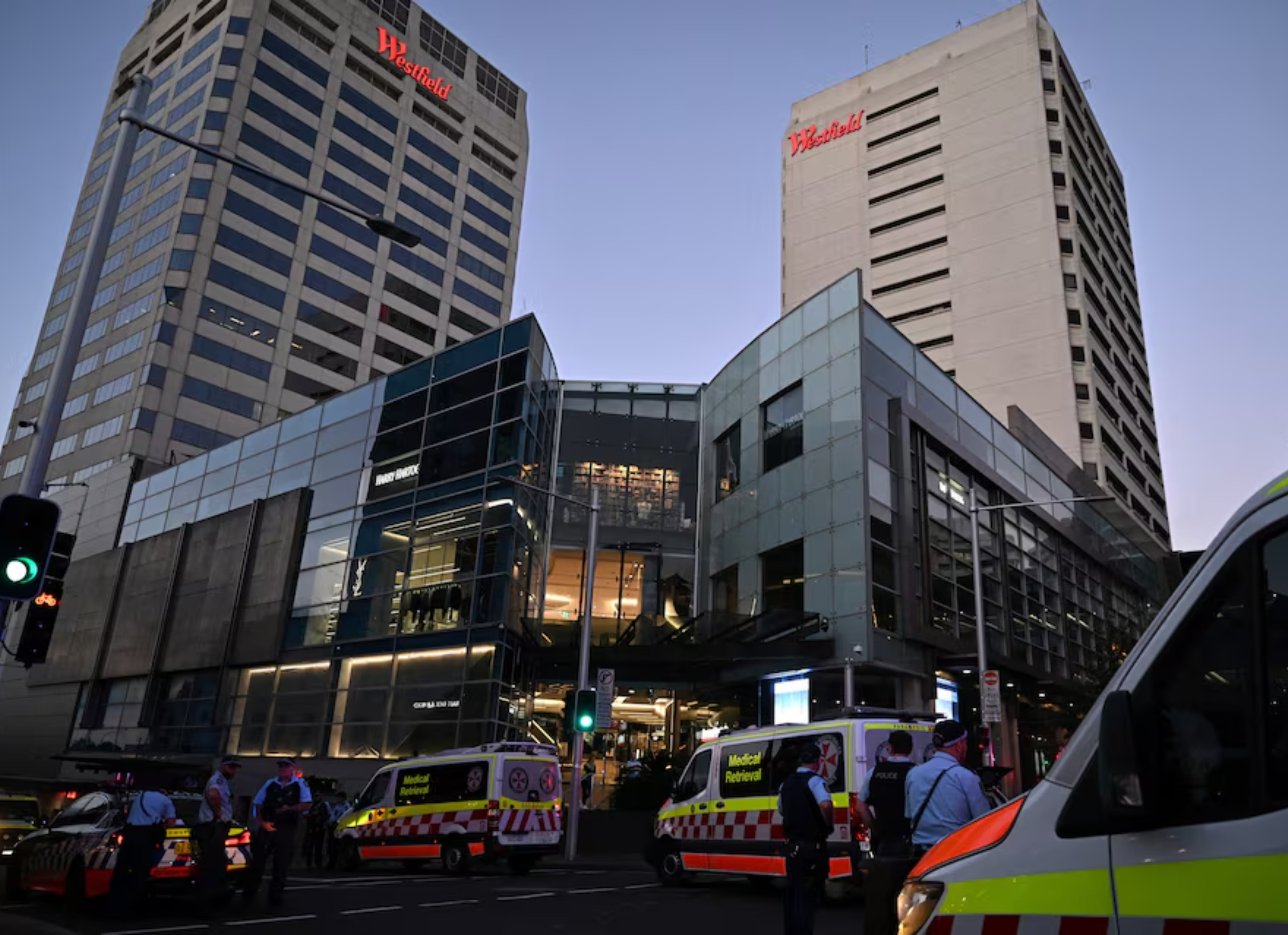 emergency service workers stand near bondi junction after multiple people were stabbed inside the westfield bondi junction shopping centre in sydney april 13 2024 aap image steven saphore via photo reuters