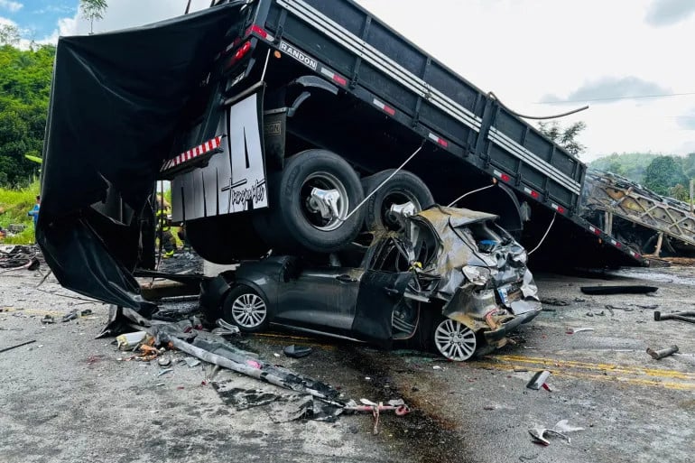 a car is crushed after a packed bus collided with a truck on the fernao dias national highway near teofilo otoni brazil on december 21 2024 photo reuters