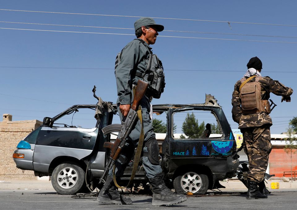 afghan police officer inspects a damaged van after a blast in kabul afghanistan june 3 2021 photos reuters