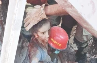 rescue officials take a child out of the ruble of one the three houses which collapsed in larkana due to an lpg cylinder blast that left one dead and 14 injured photo ppi