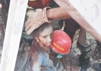 rescue officials take a child out of the ruble of one the three houses which collapsed in larkana due to an lpg cylinder blast that left one dead and 14 injured photo ppi