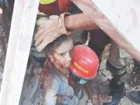 rescue officials take a child out of the ruble of one the three houses which collapsed in larkana due to an lpg cylinder blast that left one dead and 14 injured photo ppi