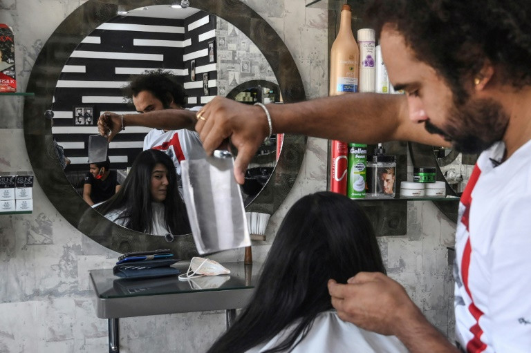 abbas s fringe style is proving a hit in the conservative nation with customers flocking to his shop in the eastern city of lahore afp