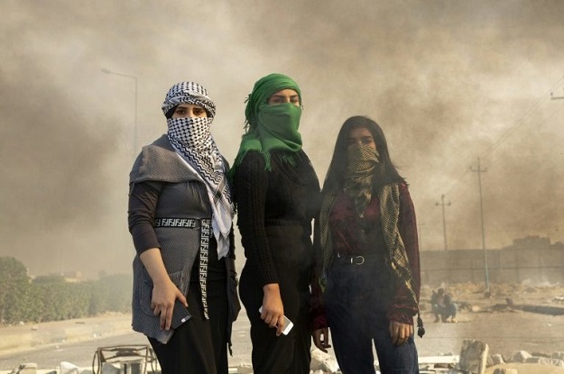 Iraqi women are challenging taboos by taking a front seat role in the country's protest movement .PHOTO: AFP