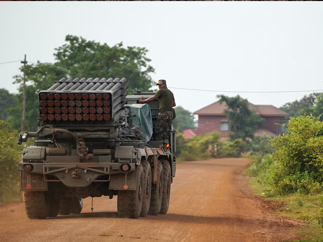 A Cambodian military personnel stands on a BM-21 Grad multiple rocket launcher, around 40 km (24 miles) from the disputed Ta Moan Thom temple. Photo: Reuters