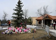 workers install a fence around a makeshift memorial for the victims two days after a deadly mass shooting took place at a school in the town of tumbler ridge british columbia canada february 12 2026 photo reuters
