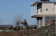 a turkish soldier stands guard as army and security personnel search a field after a piece of ammunition fell following the interception of a missile launched from iran by a nato air defence system in diyarbakir turkey march 9 2026 photo reuters