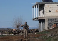 a turkish soldier stands guard as army and security personnel search a field after a piece of ammunition fell following the interception of a missile launched from iran by a nato air defence system in diyarbakir turkey march 9 2026 photo reuters