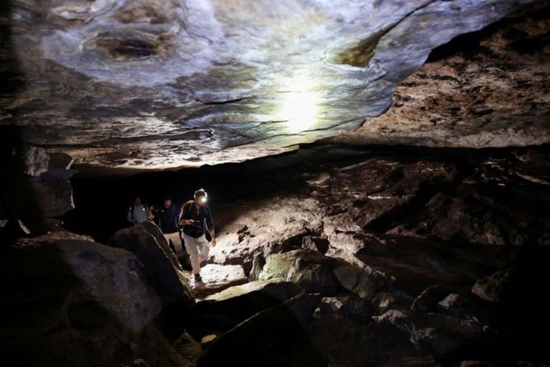 people walk inside a cave in cerro azul a large area protected for its archaeological importance in san jose de guaviare colombia september 23 2024 photo reuters