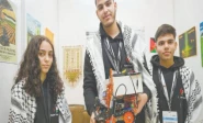palestinian participants razan shawar jehad abudayyah and mustafa assi pose with their robot design at the world robot olympiad in singapore photo afp