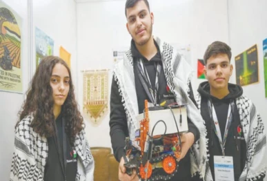 palestinian participants razan shawar jehad abudayyah and mustafa assi pose with their robot design at the world robot olympiad in singapore photo afp