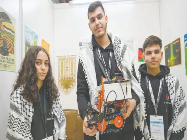 palestinian participants razan shawar jehad abudayyah and mustafa assi pose with their robot design at the world robot olympiad in singapore photo afp
