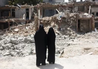 iranian women look at a building which was damaged in a us and israeli strike in march in tehran iran august 22 2026 reuters