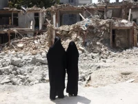 iranian women look at a building which was damaged in a us and israeli strike in march in tehran iran august 22 2026 reuters