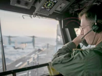 a naval officer aboard uss tripoli lha 7 oversees flight operations from the control tower as the amphibious assault ship sails in the arabian sea us warships and aircraft deployed to the middle east are enforcing the naval blockade against iran photo centcom x