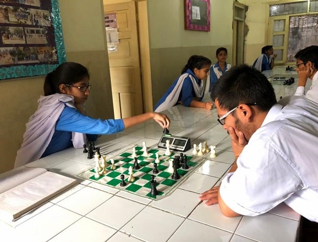 Maliha Ali, 14, having a friendly match with a student from BVS Boys School at SMB Fatima Jinnah Government Girl School, in Karachi, Pakistan. Picture taken February 24, 2017. PHOTO: Thomson Reuters Foundation