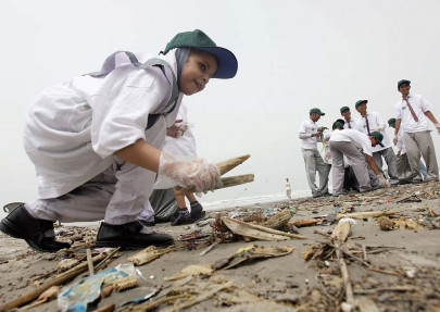 little environmentalists small hands clearing up a big mess little environmentalists small hands clearing up a big mess