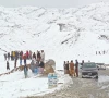 people gather along a snow covered area near the pak afghan border in chaman photo afp