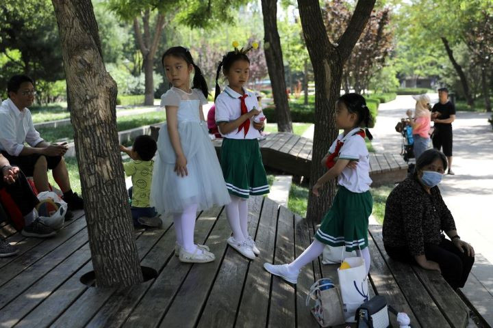 children play next to adults at a park in beijing china june 1 2021 reuters tingshu wang