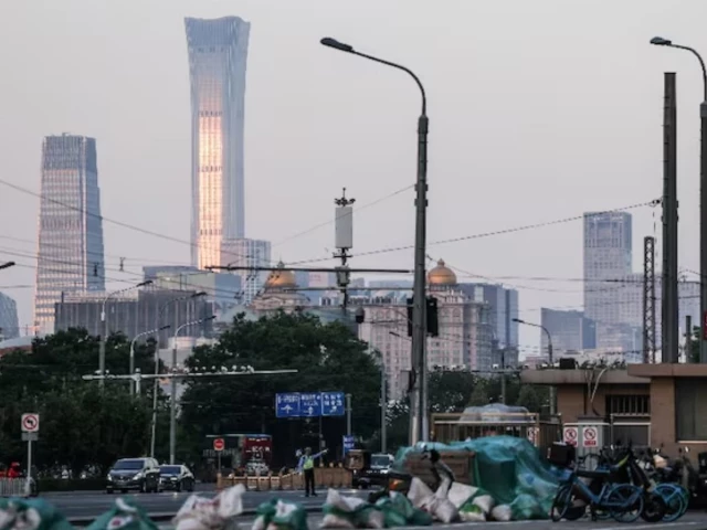 a police officer directs traffic in the street with beijing central business district skyline seen in the background ahead of us president donald trump s visit to china in beijing china may 11 2026 photo reuters a police officer directs traffic in the street with beijing central business district skyline seen in the background ahead of us president donald trump s visit to china in beijing china may 11 2026 photo reuters