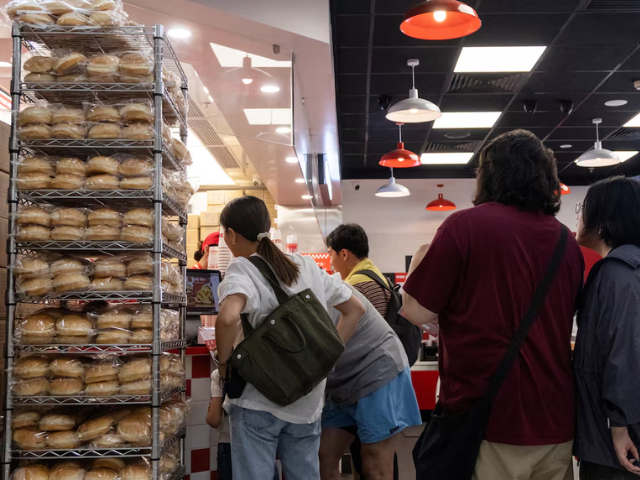 People queue at a Five Guys fast-food restaurant after the U.S. burger chain opened its first two locations earlier this month, in Beijing, China, August 15, 2026. PHOTO: Reuters