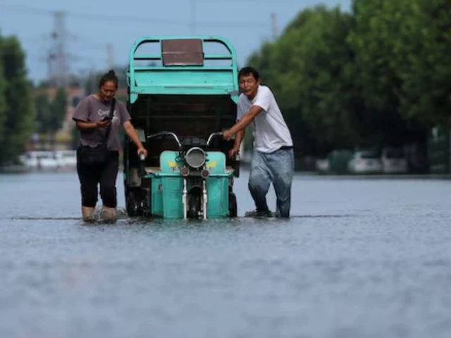 residents push a vehicle as they wade through a flooded street following heavy rainfall brought by remnants of typhoon dolphin in xuchang henan province china on august 13 2026 photo reuters file residents push a vehicle as they wade through a flooded street following heavy rainfall brought by remnants of typhoon dolphin in xuchang henan province china on august 13 2026 photo reuters file