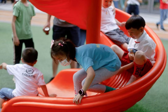 children play at a playground inside a shopping complex in shanghai china june 1 2021 photo reuters file children play at a playground inside a shopping complex in shanghai china june 1 2021 photo reuters file