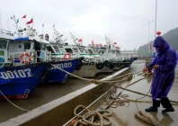 a crew member secures a boat at nanyue pier as typhoon dolphin approaches in yueqing bay wenzhou zhejiang province china august 5 2026 cnsphoto via reuters
