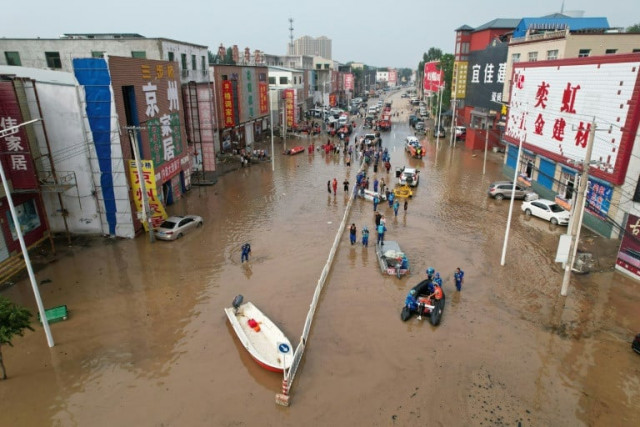 this aerial view shows rescue teams working in a flooded village after heavy rains in zhuozhou baoding city in northern china s hebei province on august 2 2023 photo afp this aerial view shows rescue teams working in a flooded village after heavy rains in zhuozhou baoding city in northern china s hebei province on august 2 2023 photo afp