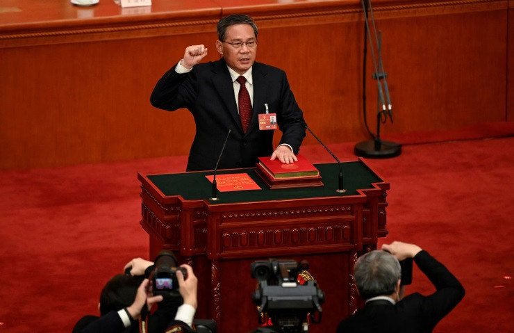 china s newly elected premier li qiang takes an oath after being elected during the fourth plenary session of the national people s congress npc at the great hall of the people in beijing china on march 11 2023 greg baker pool via reuters