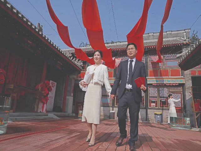 bride wang jieyu and zhan yongqiang pose for a photograph with their marriage certificates after they register at the huguo guanyin temple in beijing photo reuters