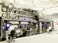 workers are seen in front of a high na euv lithography system at an intel facility in hillsboro oregon us in this handout image obtained by reuters on april 19 2024 intel corporation handout via reuters