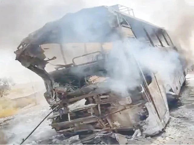 smoke rises from the mangled remains of a bus that caught fire after colliding head on with an oil laden vehicle on the cpec route in balochistan s panjgur district photo nni