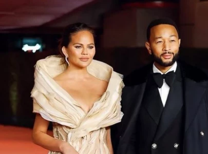 chrissy teigen steals spotlight in sheer black dress at king s trust gala with john legend
