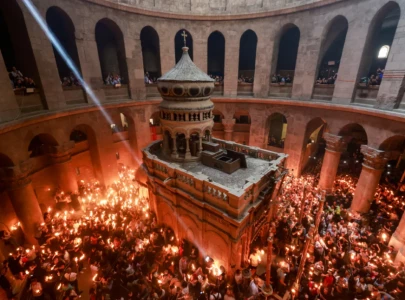 thousands of christians gather at holy sepulchre for sacred holy fire ceremony