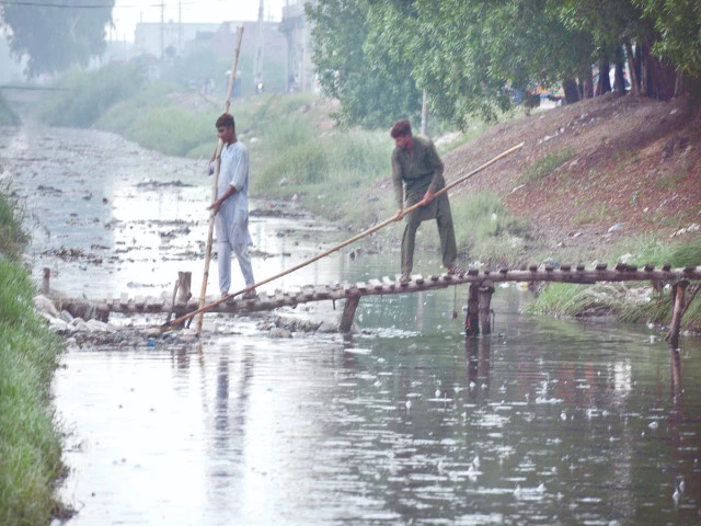 water and sanitation agency workers clean a sewerage drain amidst a downpour in faisalabad sanitation and water supply responsibilities in several more cities have been transferred from municipal corporations to wasa photo app
