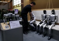 a staff member places a unitree s r1 humanoid robot back in its seat at a unitree store in beijing china august 1 2026 reuters
