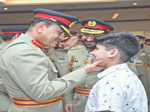 coas gen asim munir interacts with the son of a martyr at an investiture ceremony at the ghq photo ppi coas gen asim munir interacts with the son of a martyr at an investiture ceremony at the ghq photo ppi
