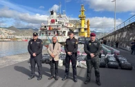 this undated handout photo released on january 12 2026 by spanish national police shows spanish police posing in front of some of the nearly 10 tons of cocaine seized on a cargo ship that was sailing across the atlantic between brazil and spain at the port of santa cruz de tenerife in spain s canary islands photo afp spanish national police