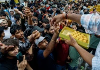 a man hands out sweets to supporters of india s cockroach janta party cjp as they celebrate after india s education minister dharmendra pradhan resigned following days of protests demanding his resignation over national eligibility cum entrance test neet examination paper leaks in new delhi india july 25 2026 reuters