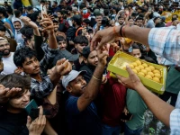 a man hands out sweets to supporters of india s cockroach janta party cjp as they celebrate after india s education minister dharmendra pradhan resigned following days of protests demanding his resignation over national eligibility cum entrance test neet examination paper leaks in new delhi india july 25 2026 reuters
