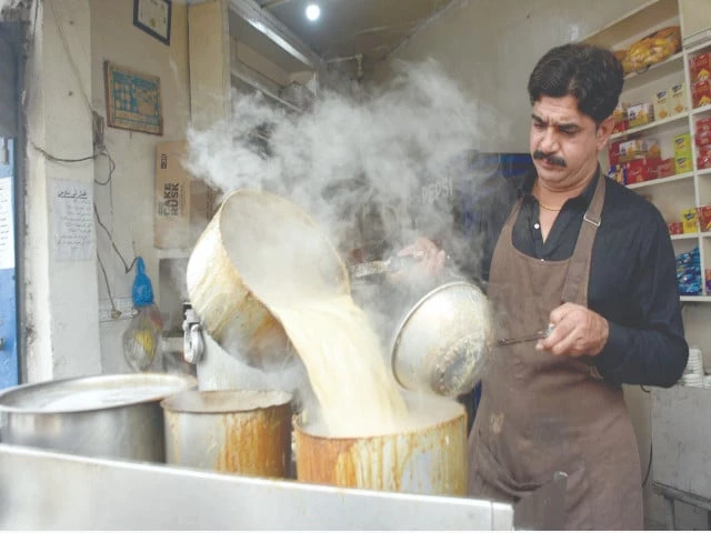 a vendor serves tea on a chilly evening in lahore as cold and dry weather is forecast across most of the country on thursday photo online a vendor serves tea on a chilly evening in lahore as cold and dry weather is forecast across most of the country on thursday photo online