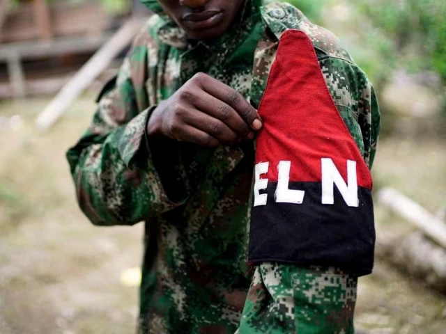 a rebel of colombia s marxist national liberation army eln shows his armband while posing for a photograph in the northwestern jungles colombia august 31 2017 photo reuters a rebel of colombia s marxist national liberation army eln shows his armband while posing for a photograph in the northwestern jungles colombia august 31 2017 photo reuters