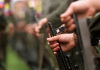 a colombian guerilla woman holds her ak 47 as she takes part in a line of rebels during an army parade of fighters of the farc in villa colombia camp near san vicente del caguan caqueta province colombia photo reuters